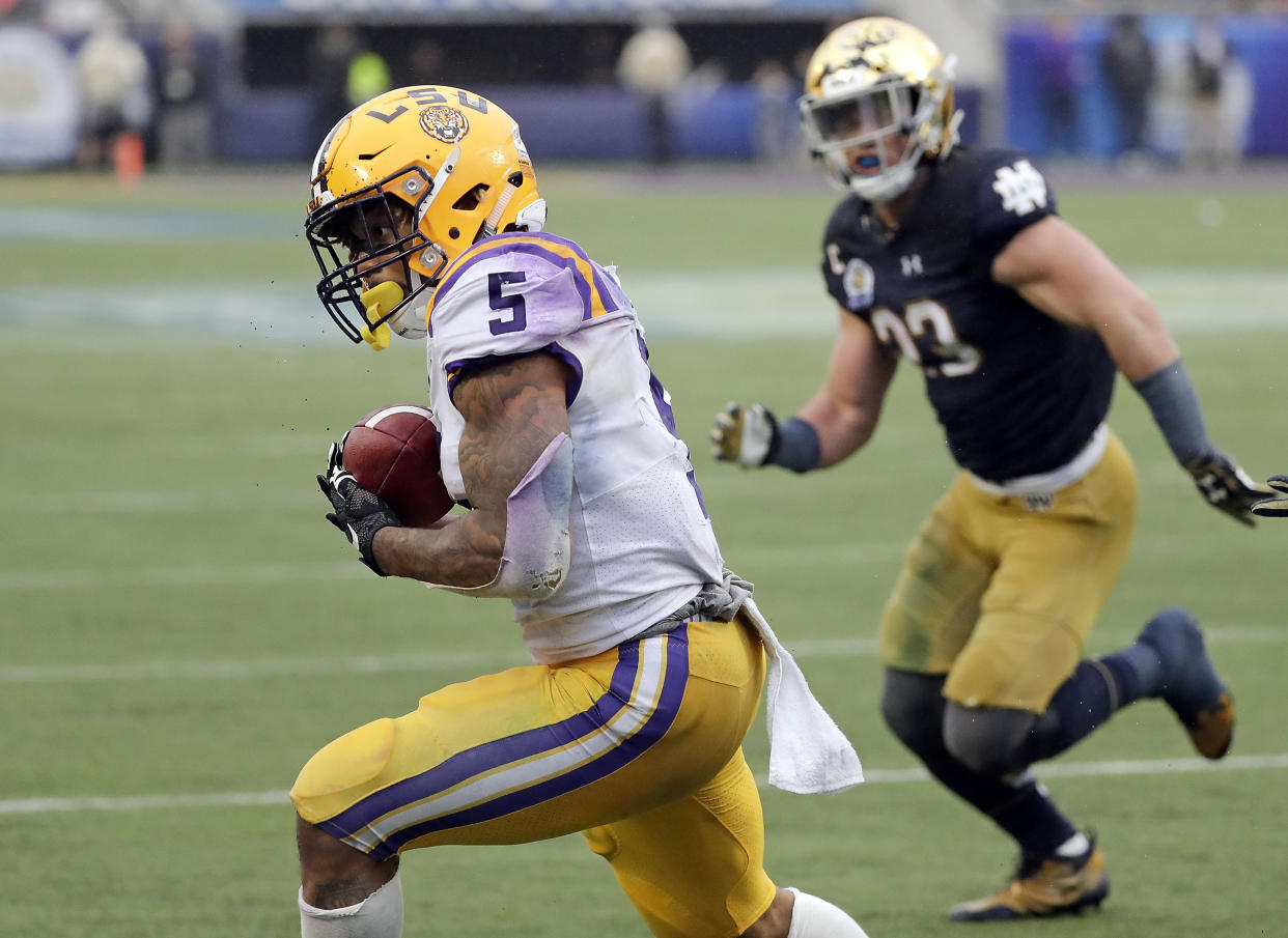 LSU running back Derrius Guice (5) makes a reception to score a touchdown in front of Notre Dame linebacker Drue Tranquill during the second half of the Citrus Bowl NCAA college football game, Monday, Jan. 1, 2018, in Orlando, Fla. Notre Dame won 21-17. (AP Photo/John Raoux)