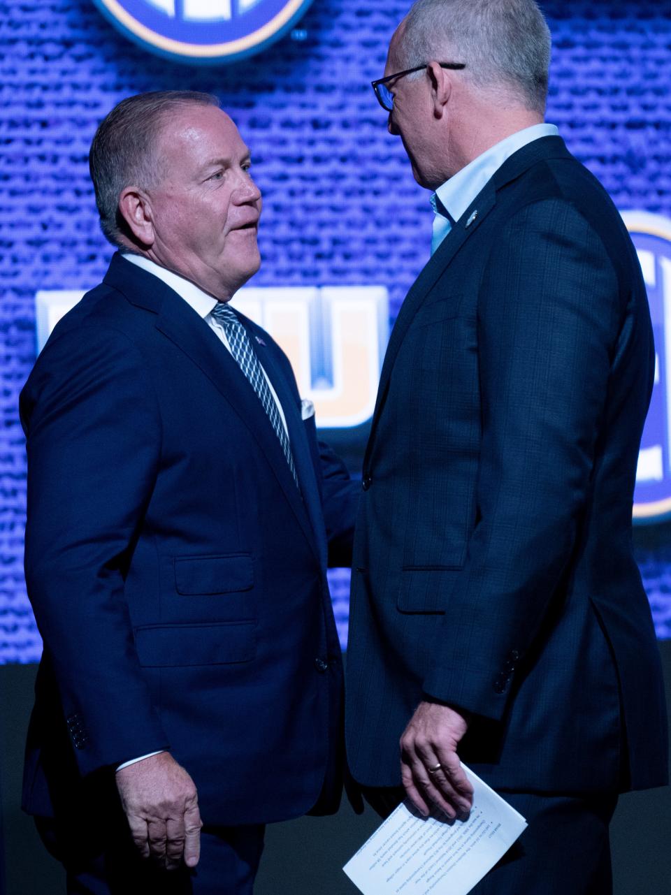 LSU football coach Brian Kelly, left, is greeted by SEC Commissioner Greg Sankey at SEC media days in Nashville, Tenn., on Monday. SEC officials announced that 2024 media days will be in Dallas next year, the first time the SEC will conduct its annual summer gathering in Texas.