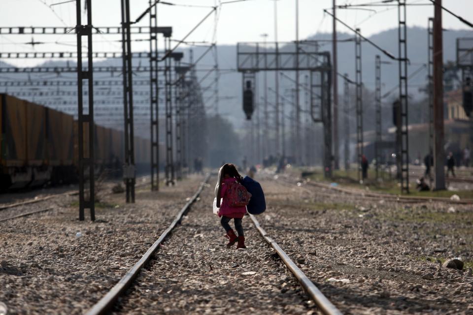 A child walks on a train track as migrants and refugees wait to cross the Greek-Macedonian border. EU President Donald Tusk on March 3, 2016 issued a stark warning to economic migrants not to come to Europe.