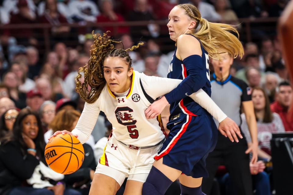 Feb. 11, 2024: South Carolina Gamecocks guard Tessa Johnson (5) drives around UConn Huskies guard Paige Bueckers (5) in the first half at Colonial Life Arena in Columbia, South Carolina.