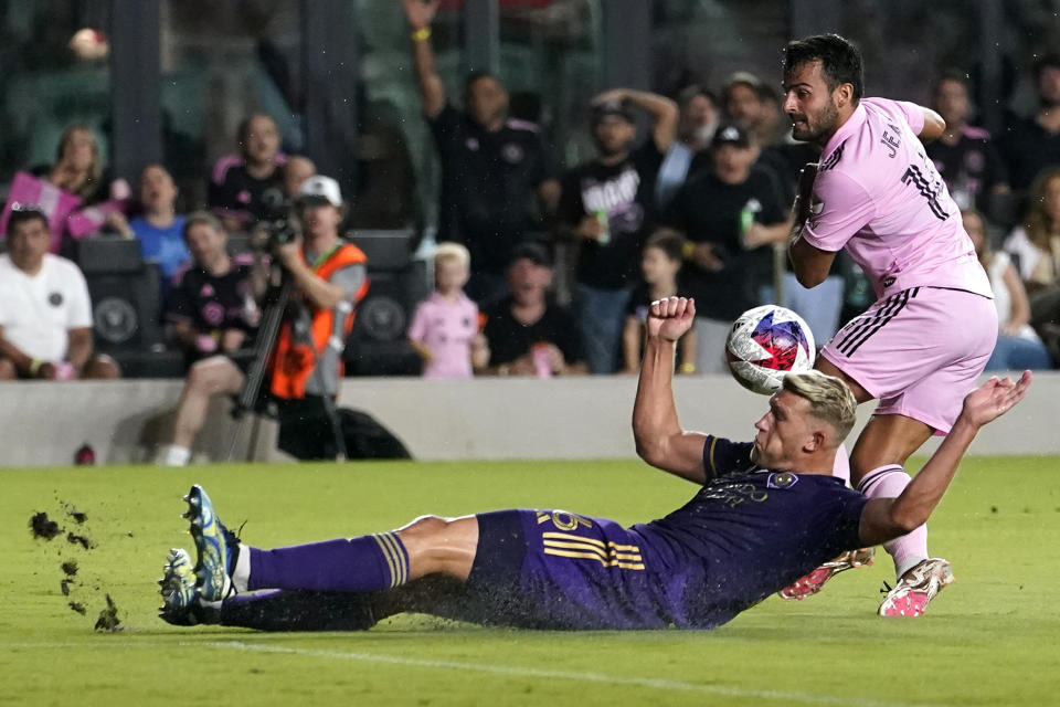 Orlando City defender Robin Jansson falls to the pitch as he goes for the ball against Inter Miami forward Corentin Jean, right, during the second half of an MLS soccer match, Saturday, May 20, 2023, in Fort Lauderdale, Fla. (AP Photo/Lynne Sladky)