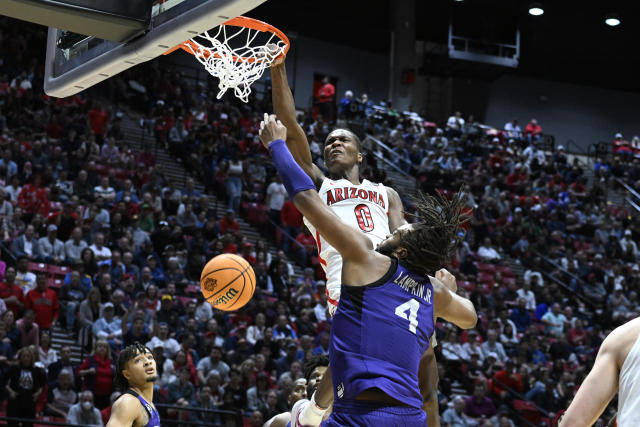 Arizona guard Bennedict Mathurin (0) sucks on TCU center Eddie Lampkin (4) during the second half of a second-round NCAA college basketball tournament game, Sunday, March 20, 2022, in San Diego. (AP Photo/Denis Poroy)