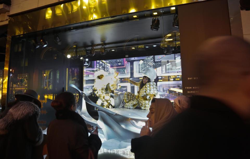 This Nov. 20, 2013 photo shows live models in a Christmas window called "Sleigh Ride" at Barneys New York. The window is one of four holiday windows promoting a charitable collaboration between Barneys and Shawn "Jay-Z" Carter. (AP Photo/Bebeto Matthews)