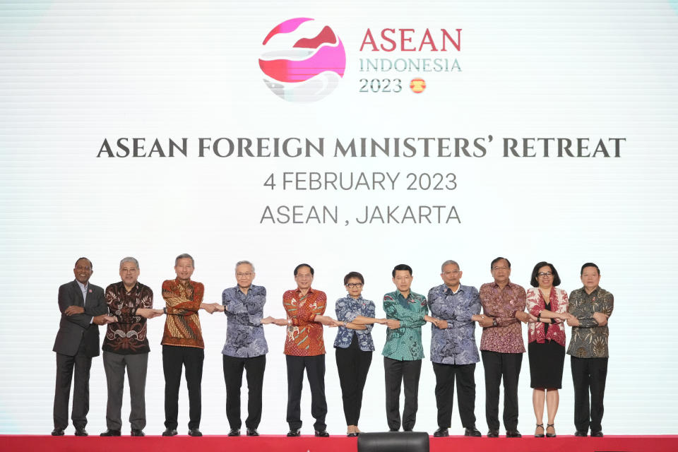 From left to right; Malaysian Foreign Minister Zambry Abdul Kadir, Philippine's Foreign Secretary Enrique Manalo, Singaporean Foreign Minister Vivian Balakrishnan, Thailand's Foreign Minister Don Pramudwinai, Vietnam's Foreign Minister Bui Thanh Son, Indonesian Foreign Minister Retno Marsudi, Laotian Foreign Minister Saleumxay Kommasith, Brunei's Second Minister of Foreign Affair Erywan Yusof, Cambodia's Foreign Minister Prak Sokhonn, East Timor's Foreign Minister Adaljiza Magno and ASEAN Secretary General Kao Kim Hourn hold hands as they pose for a group photo during the Association of Southeast Asian Nations (ASEAN) foreign ministers retreat in Jakarta, Indonesia, Saturday, Feb. 4, 2023. (AP Photo/Achmad Ibrahim)