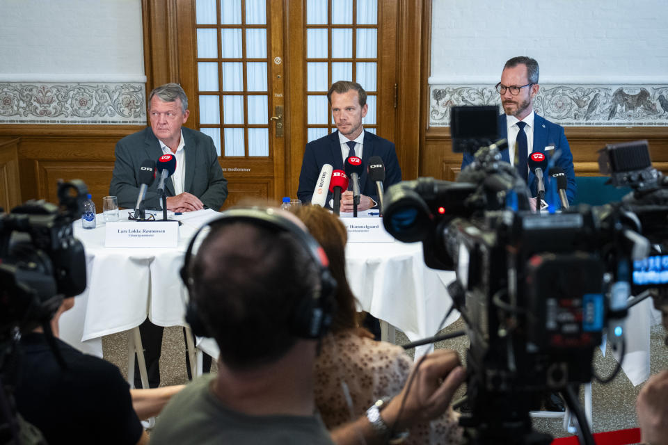 From left, Minister of Foreign Affairs Lars Loekke Rasmussen, Minister of Justice Peter Hummelgaard and Deputy Prime Minister Jakob Ellemann-Jensen present a bill on a Quran burning ban on a doorstep in Christiansborg, Copenhagen, Friday, Aug. 25, 2023. (Martin Sylvest/Ritzau Scanpix via AP)