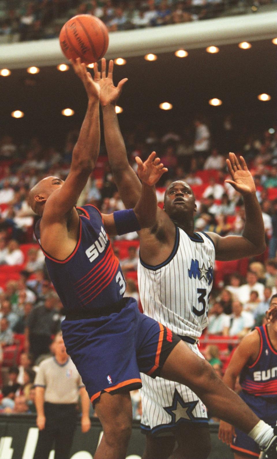 Shaquille O'Neal challenges Charles Barkley of the Phoenix Suns during a 135-129 win in Orlando, Fla. on October 24, 1994. (Allsport)