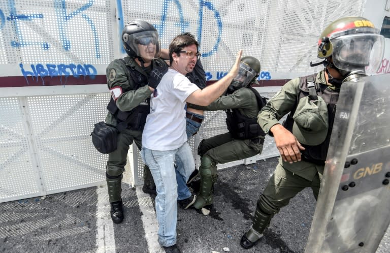 Venezuelan opposition deputy Freddy Guevara is held by members of the Bolivarian National Guard during a protest against the government of President Nicolas Maduro