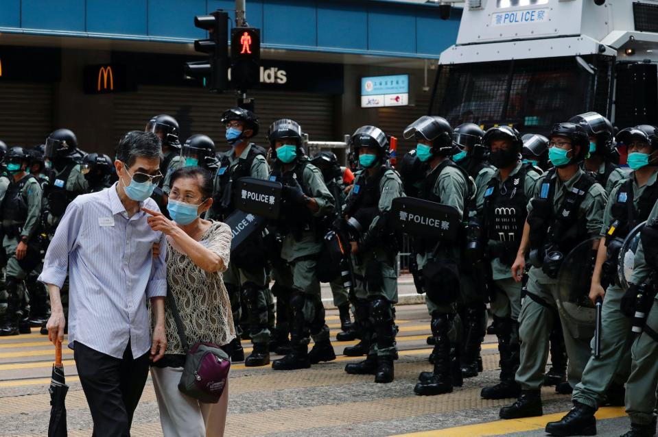 Hong kong couple walks by police.JPG