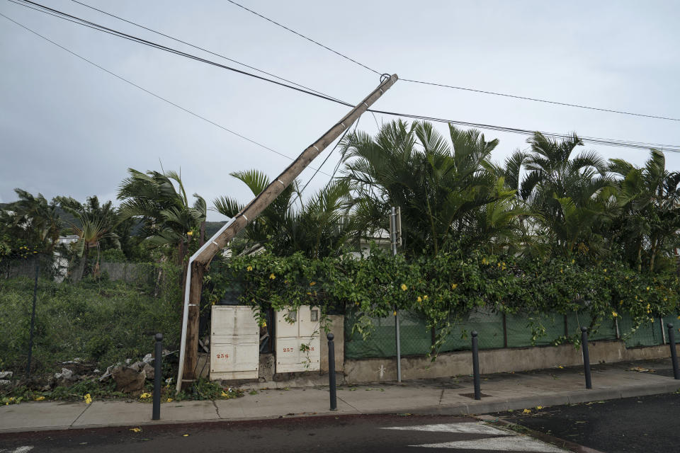 An electrical pole is damaged in the town of La Plaine Saint-Paul on the French Indian Ocean island of Reunion, Monday, Jan. 15, 2024. Authorities urged residents on the French Indian Ocean island of Reunion to shelter indoors Sunday as a powerful storm bore down packing hurricane-force winds and Meteo France warned of winds that could top 250 kph (155 mph) Monday. (AP Photo/Lewis Joly)