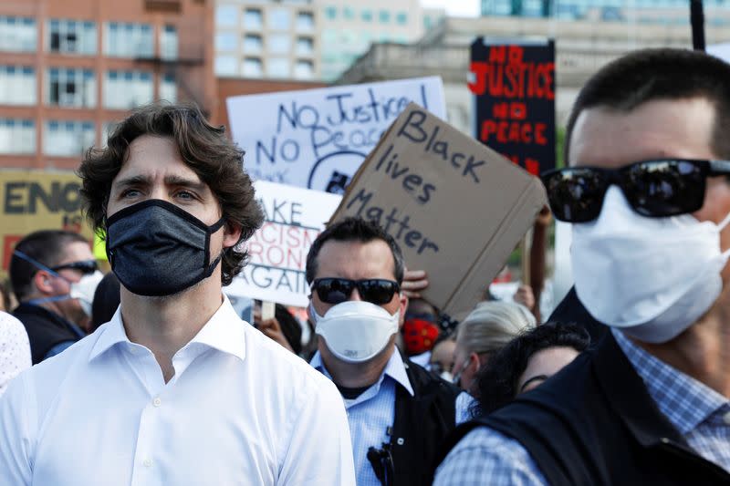 Canada's Prime Minister Justin Trudeau wears a mask as he takes part in a rally against the death in Minneapolis police custody of George Floyd, on Parliament Hill, in Ottawa