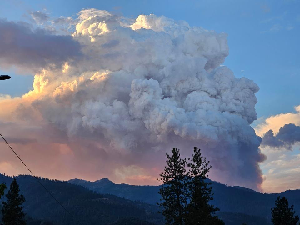 Smoke is seen rising from the Trinity Mountains after a forest fire burned at Stuart Fork Trailhead on Tuesday, Aug. 15, 2023.