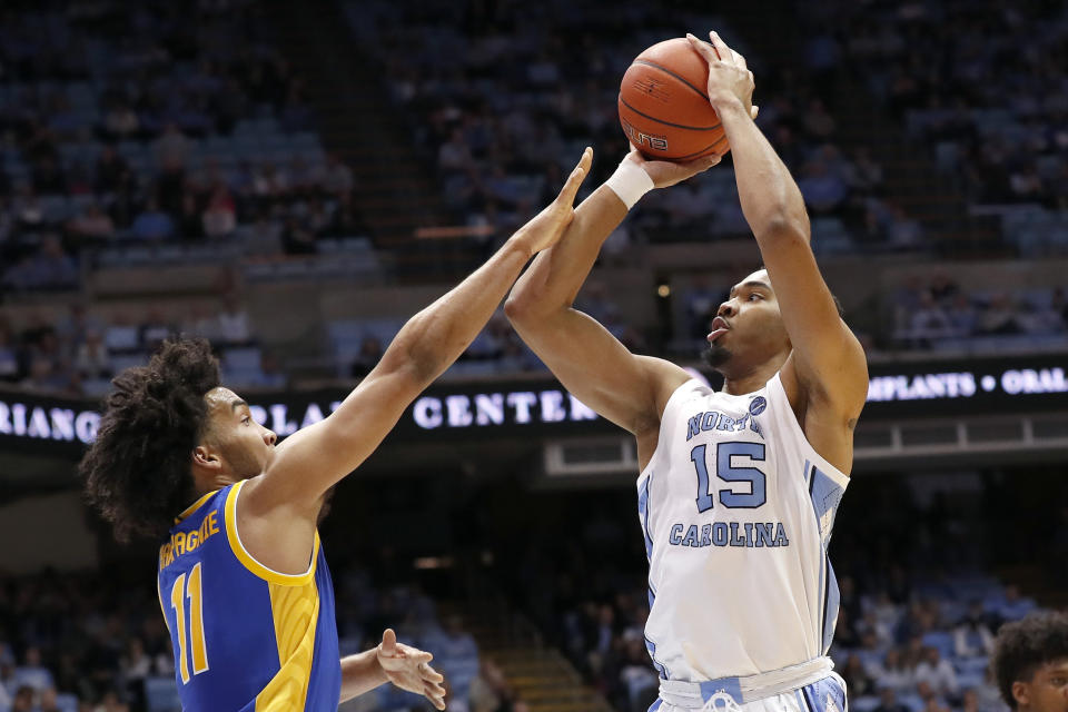 North Carolina forward Garrison Brooks (15) shoots against Pittsburgh guard Justin Champagnie (11) during the first half of an NCAA college basketball game in Chapel Hill, N.C., Wednesday, Jan. 8, 2020. (AP Photo/Gerry Broome)