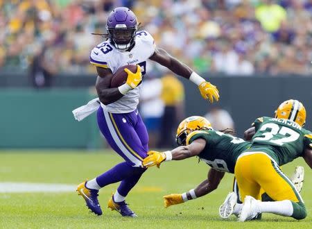 Sep 16, 2018; Green Bay, WI, USA; Minnesota Vikings running back Dalvin Cook (33) rushes with the football during the second quarter against the Green Bay Packers at Lambeau Field. Mandatory Credit: Jeff Hanisch-USA TODAY Sports