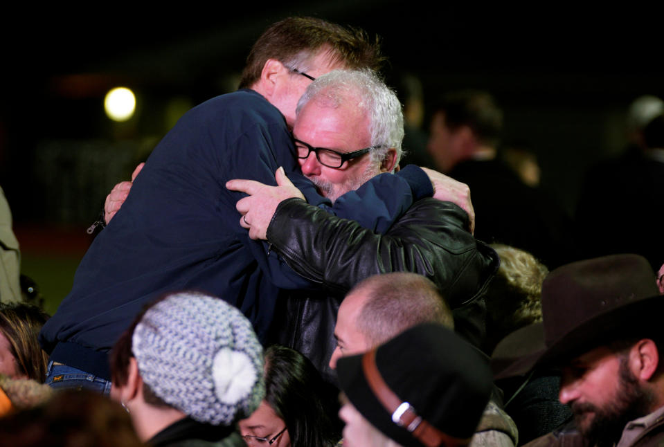 Texas Lt. Gov. Dan Patrick, left, hugs Stephen Willeford, the man who stopped alleged shooter Devin Kelley. at a gathering in Floresville, Texas. (Photo: Rick Wilking/Reuters)