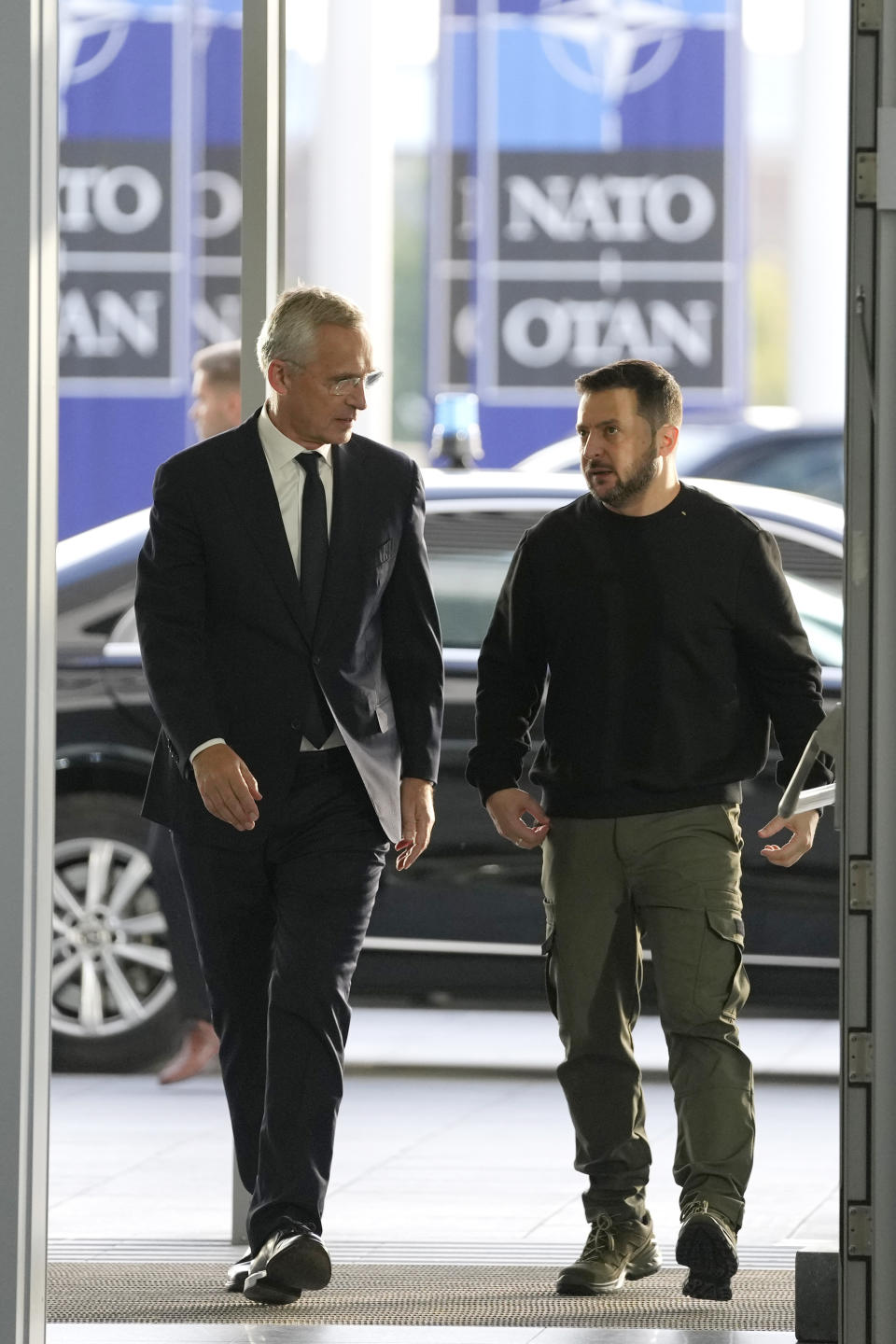 NATO Secretary General Jens Stoltenberg, left, speaks with Ukraine's President Volodymyr Zelenskyy, right, on arrival, prior to a meeting of NATO defense ministers at NATO headquarters in Brussels, Wednesday, Oct. 11, 2023. (AP Photo/Virginia Mayo)