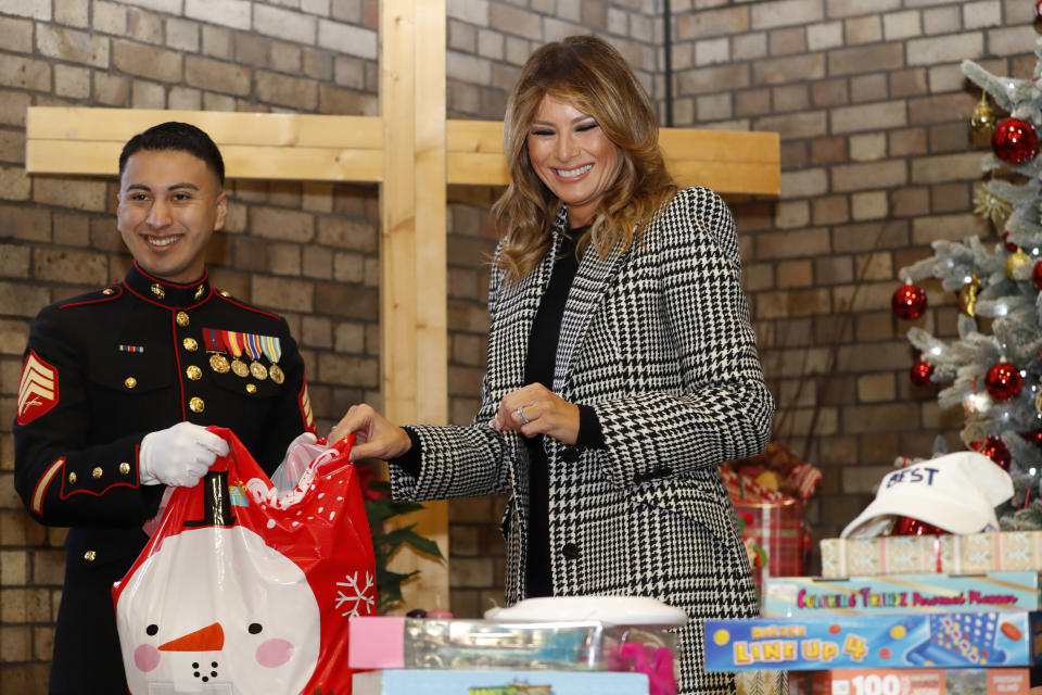 First lady Melania Trump joins local students and U.S. Marines stationed at the U.S. Embassy, wrapping holiday presents to be donated to the Salvation Army, at the Salvation Army Clapton Center in London, Wednesday, Dec. 4, 2019. (AP Photo/Alastair Grant, Pool)