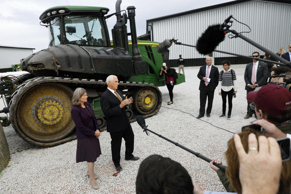 Vice President Mike Pence and Sen. Joni Ernst, R-Iowa, left, speak to reporters during a visit to the Manning Farms, Wednesday, Oct. 9, 2019, in Waukee, Iowa. (AP Photo/Charlie Neibergall)