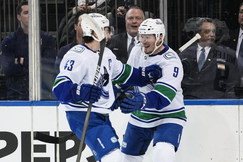 Vancouver Canucks' J.T. Miller (9) celebrates with Quinn Hughes (43) after scoring during the first period of an NHL hockey game against the New York Rangers, Monday, Jan. 8, 2024, in New York. (AP Photo/Frank Franklin II)