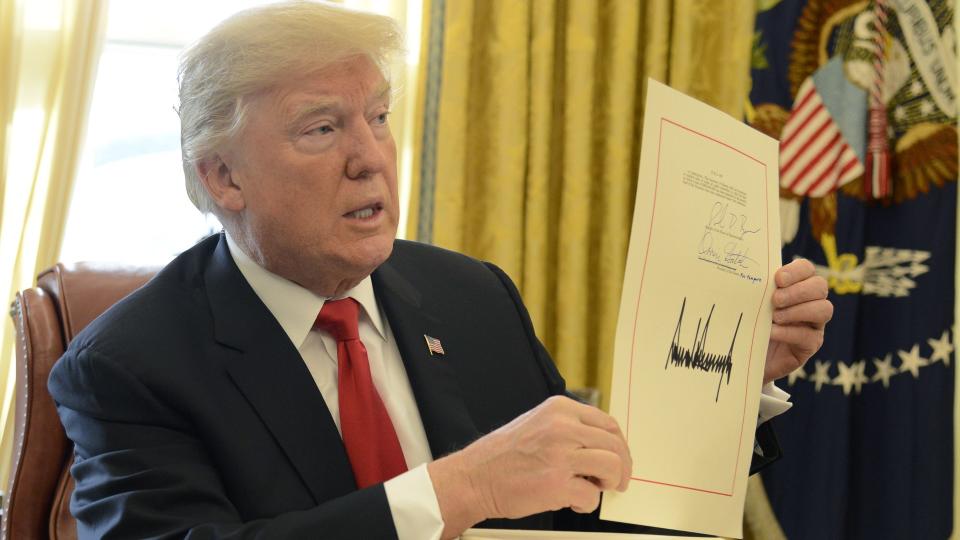 President Donald Trump signs Tax Cut and Jobs Act in 2017