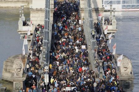 People protest against the bill that would undermine Central European University, a liberal graduate school of social sciences founded by U.S. financier George Soros in Budapest, Hungary, April 9, 2017. REUTERS/Bernadett Szabo