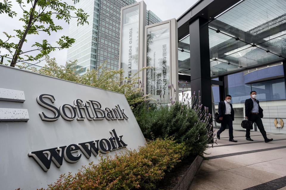 Pedestrians walk outside the headquarters for Japanese company SoftBank Group in Tokyo Portcity Takeshiba on May 11, 2023. (Photo by Richard A. Brooks / AFP) (Photo by RICHARD A. BROOKS/AFP via Getty Images)