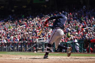 Atlanta Braves' Ozzie Albies singles during the second inning of an opening day baseball game against the Washington Nationals at Nationals Park, Thursday, March 30, 2023, in Washington. Orlando Arcia scored on the play. (AP Photo/Alex Brandon)