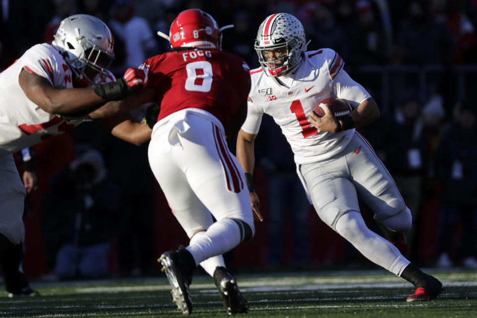 Ohio State quarterback Justin Fields (1) rushes against Rutgers linebacker Tyshon Fogg (8) during the first half of an NCAA college football game Saturday, Nov. 16, 2019, in Piscataway, N.J. (AP Photo/Adam Hunger)