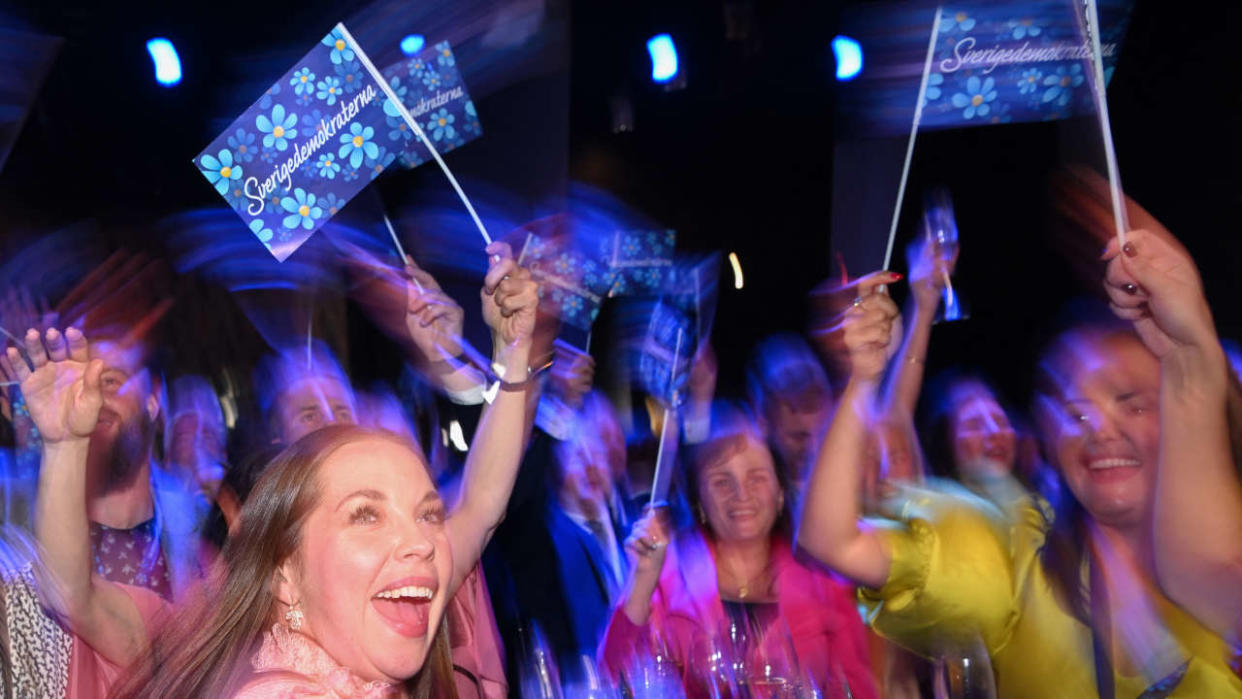 Supporters of the Sweden Democrats cheer during the Party's election night in Nacka, near Stockholm on September 11, 2022, after exit polls were released during the general elections in Sweden. (Photo by Jonathan NACKSTRAND / AFP) / ALTERNATIVE CROP