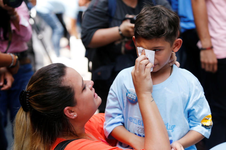 Michelle Gomes, daughter of Patrick Gomes who was the in-flight supervisor onboard the missing Malaysia Airlines flight MH370, comforts her son Rafael Gomes during its fifth annual remembrance event in Kuala Lumpur, Malaysia March 3, 2019. REUTERS/Lai Seng Sin