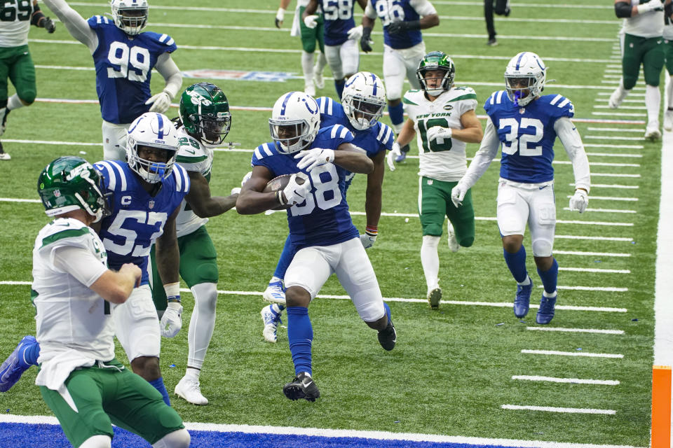 Indianapolis Colts cornerback T.J. Carrie (38) runs in for a touchdown after an interception against the New York Jets in the second half of an NFL football game in Indianapolis, Sunday, Sept. 27, 2020. (AP Photo/AJ Mast)