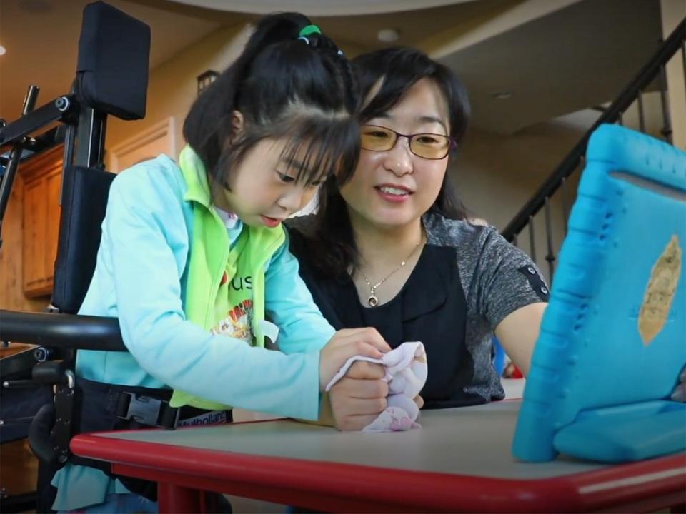 Soo-Kyung Lee and Yuna at home. Yuna, now aged 8, suffers from a brain disorder related to the FOXG1 gene: The New York Times