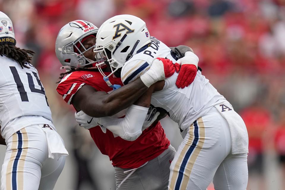 Aug 31, 2024; Columbus, OH, USA; Ohio State Buckeyes linebacker Arvell Reese (20) tackles Akron Zips wide receiver Paul Davis (16) during the second half of the NCAA football game at Ohio Stadium. Ohio State won 52-6.