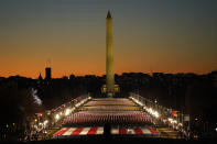 A field of flags is spread across the National Mall, with the Washington Monument in the background on Tuesday, Jan. 19, 2021, as seen from the West Front of the U.S. Capitol on the evening ahead of the 59th Presidential Inauguration in Washington. (AP Photo/Susan Walsh)