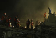 Members of rescue services search for survivors in the debris of a collapsed building in Izmir, Turkey, early Saturday, Oct. 31, 2020. Rescue teams on Saturday ploughed through concrete blocs and debris of eight collapsed buildings in Turkey's third largest city in search of survivors of a powerful earthquake that struck Turkey's Aegean coast and north of the Greek island of Samos, killing dozens. Hundreds of others were injured. (AP Photo/Emrah Gurel)