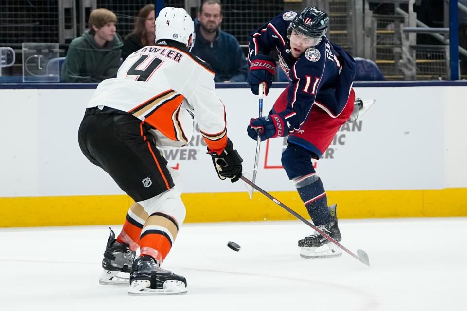 Oct 24, 2023; Columbus, Ohio, USA; Columbus Blue Jackets center Adam Fantilli (11) shoots past Anaheim Ducks defenseman Cam Fowler (4) during the third period of the NHL game at Nationwide Arena. The Blue Jackets lost 3-2 (OT).