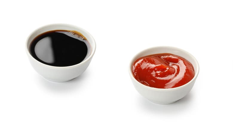 Bowls of soy sauce and ketchup