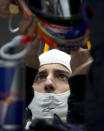 Red Bull driver Daniel Ricciardo of Australia prepares to wear his helmet during the practice session ahead of Sunday's Chinese Formula One Grand Prix at Shanghai International Circuit in Shanghai, China Friday, April 18, 2014. (AP Photo/Andy Wong)