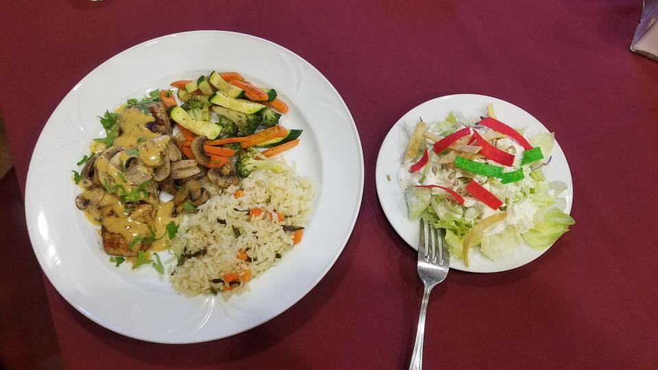 Chipotle mayo salmon with grilled mushrooms, served with sautéed vegetables, poblano rice and side salad.