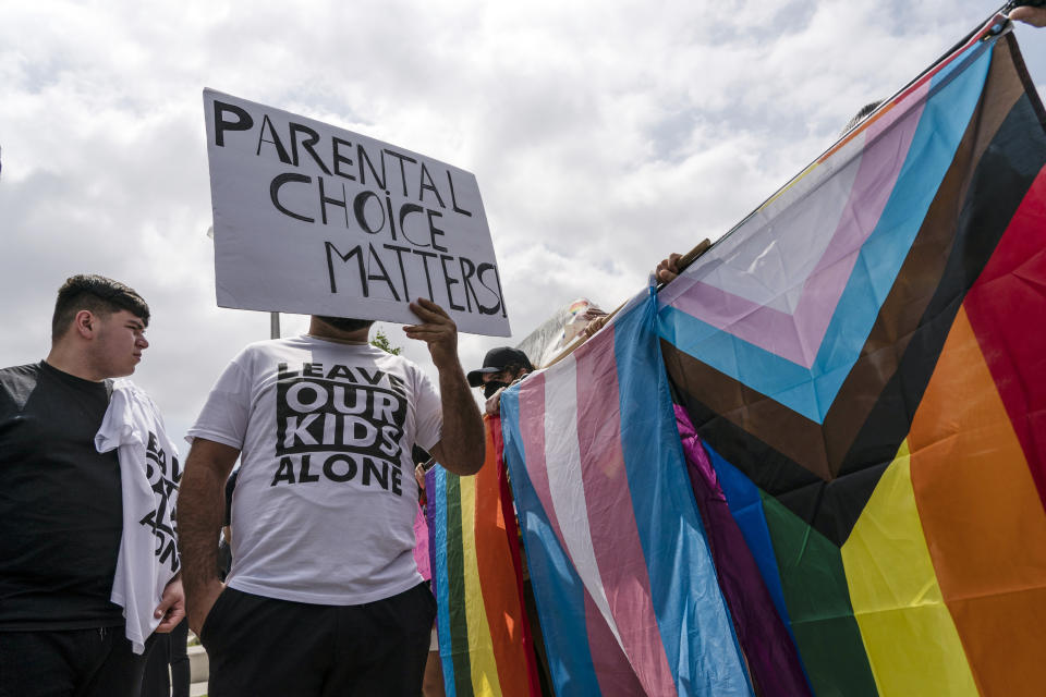 People protesting a planned Pride month assembly and counterprotesters with Pride flags stand outside Saticoy Elementary School in Los Angeles, Friday, June 2, 2023. (AP Photo/Jae C. Hong)