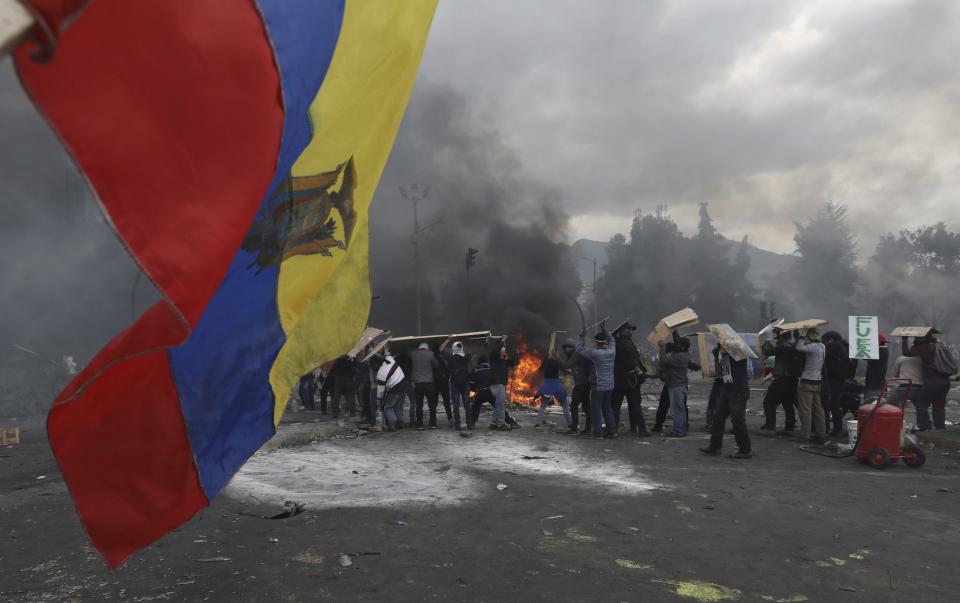 Anti-government demonstrators clash with police in Quito, Ecuador, Saturday, Oct. 12, 2019. Protests, which began when President Lenin Moreno's decision to cut subsidies led to a sharp increase in fuel prices, have persisted for days. (AP Photo/Fernando Vergara)