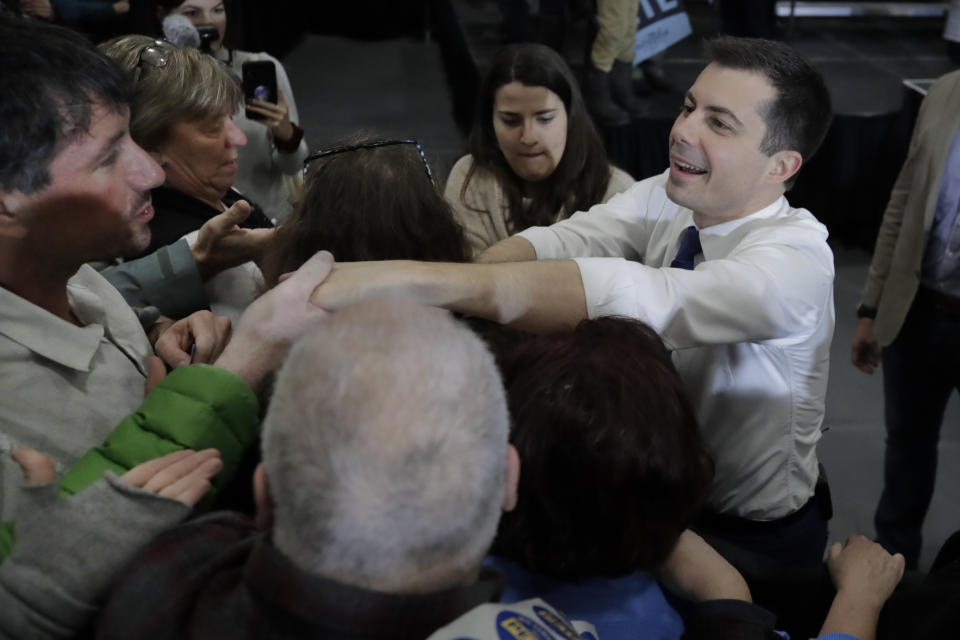 Democratic presidential candidate former South Bend, Ind. Mayor Pete Buttigieg reaches into the crowd during a campaign stop in Lebanon, N.H., Saturday, Feb. 8, 2020. (AP Photo/Charles Krupa)