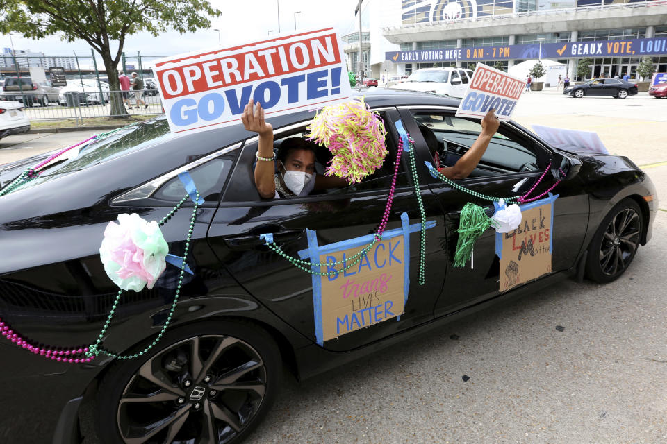 FILE - In this Oct. 24, 2020, file photo, participants drive past the Smoothie King Center, which has been converted to an early voting location, at the end of a "Parade to the Polls" event, organized by Operation Go Vote!, a collaborative of African American civic and social organizations, in New Orleans. Several years since its founding, BLM has evolved well beyond the initial aspirations of its early supporters. Now, its influence faces a test, as voters in the Tuesday, Nov. 3 general election choose or reject candidates who endorsed or denounced the BLM movement amid a national reckoning on race. (AP Photo/Rusty Costanza)