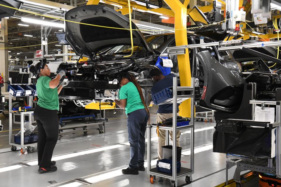 Aug 25, 2022; Tuscaloosa, AL, USA; Mercedes-Benz USI in Tuscaloosa, Ala., unveiled the new electric EQS SUV Thursday, Aug. 25, 2022. Workers on the assembly line add parts to the new electric vehicle. Mandatory Credit: Gary Cosby Jr.-Tuscaloosa News