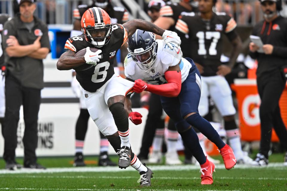 Cleveland Browns wide receiver Elijah Moore (8) runs for extra yards after a catch past Tennessee Titans safety Kevin Byard, right, during the second half on Sept. 24 in Cleveland.