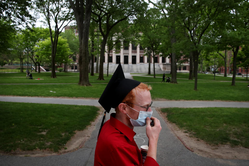 CAMBRIDGE, MA - MAY 28: Harvard Law School graduate Jesse Burbank spends time on campus before attending the online graduation ceremony in his room in Cambridge, MA on May 28, 2020. As a proctor Burbank was able to remain on campus. He earned a Juris Doctor from Harvard Law School. Harvard University postponed its commencement exercises and held an online event Thursday amid the coronavirus pandemic. Harvard, like legions of other colleges nationwide, told students in March not to return to campus after spring break ended and to take their classes online. The last time the university was forced to pivot midway through the year was in the 1940s, in the midst of World War II, when the campus was given over to military training. (Photo by Craig F. Walker/The Boston Globe via Getty Images)