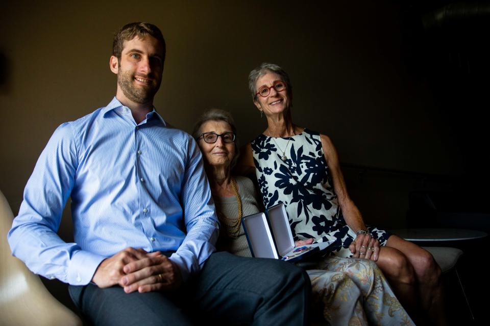 From left to right: John Tyndall Bonzelaar, Mary Tyndall Troff and Tamsin Troff pose for a portrait Tuesday, Aug. 16, 2022, at Seventy-Six Restaurant in Holland. The family gathered together to collect Frank Tyndall's long-lost WWI medals.