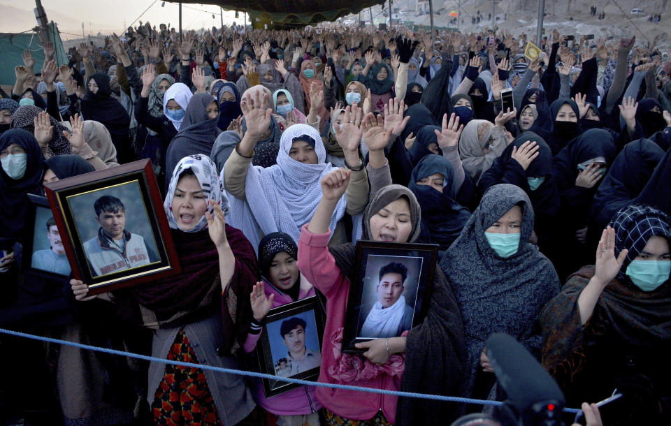 People from the Shiite Hazara community chant slogans during a sit-in to protest the killing of coal mine workers by gunmen near the Machh coal field, in Quetta, Pakistan, Wednesday, Jan. 6, 2021. Pakistan's minority Shiites continued their sit-in for a fourth straight day insisting they will bury their dead only when Prime Minister Imran Khan personally visits them to assure protection. (AP Photo/Arshad Butt)