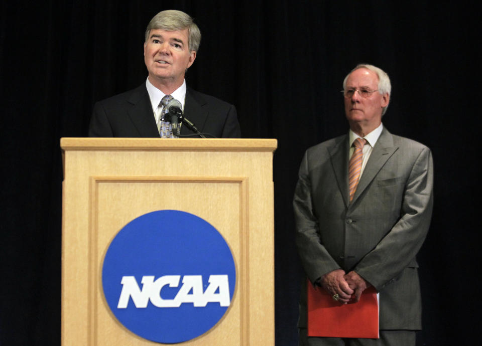 NCAA President Mark Emmert, left, announces penalties against Penn State as Ed Ray, NCAA Executive Committee chair and Oregon State University president, looks on at right, during a news conference in Indianapolis, Monday, July 23, 2012. The NCAA has slammed Penn State with an unprecedented series of penalties, including a $60 million fine and the loss of all coach Joe Paterno's victories from 1998-2011, in the wake of the Jerry Sandusky child sex abuse scandal. (AP Photo/Michael Conroy)