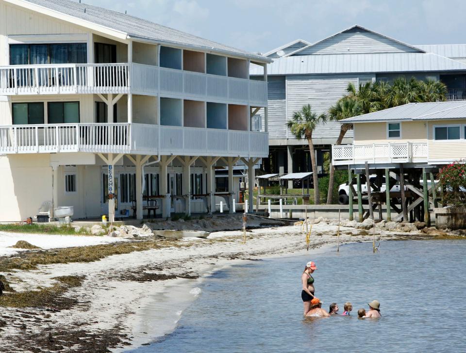 People are shown playing in the beach area of Cedar Key in 2017. An analysis by Points Upgraded determined Cedar Key as the cheapest beachfront vacation in the U.S.