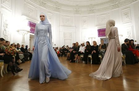 Models present creations during a show of the Firdaws fashion house led by Aishat Kadyrova, daughter of the Chechen Republic head Ramzan Kadyrov, at the Mercedes-Benz Fashion Week Russia in Moscow, Russia, March 17, 2017. REUTERS/Sergei Karpukhin